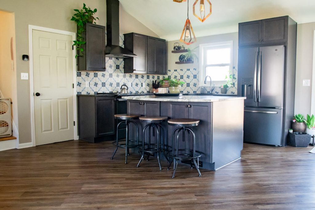 an open floor universal designed kitchen with horizontal wood flooring for a more free flowing space.
